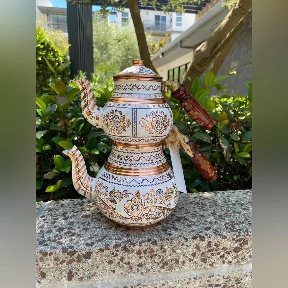 This handmade, white-painted Turkish copper teapot set features traditional